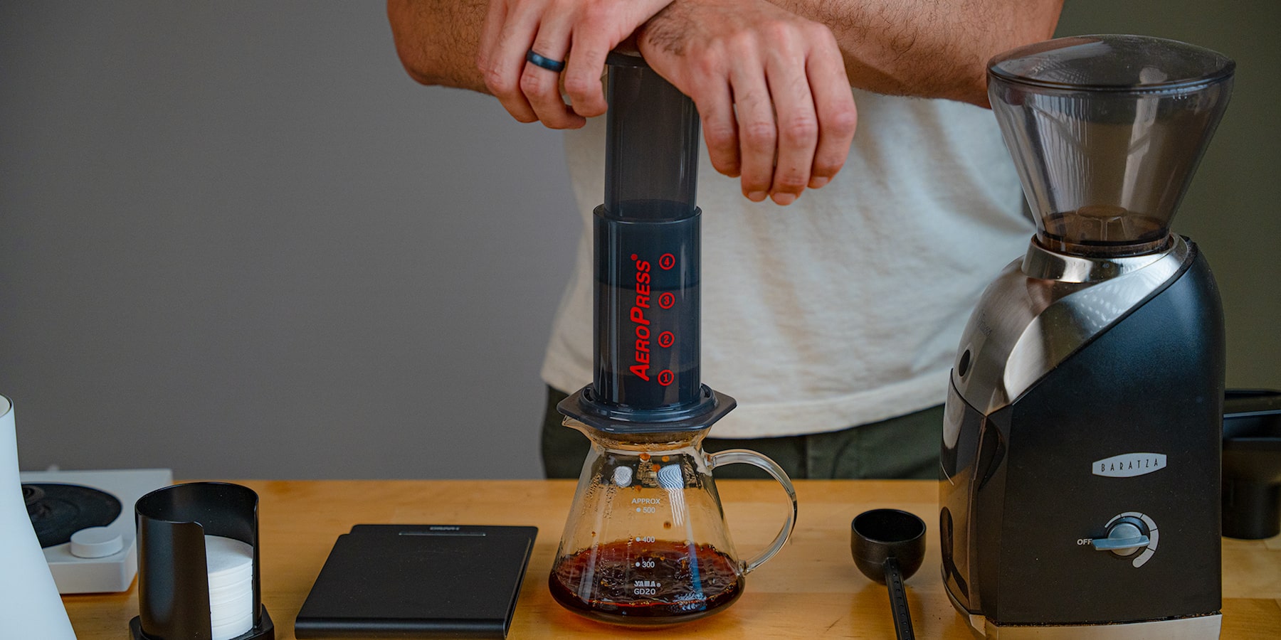 Pressing down on an Aeropress to brew coffee