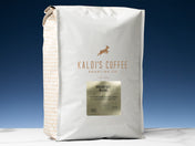 A 5lb bag of Brekfast Blend sits on marble countertop in front of an uplit blue wall