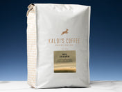 A 5lb bag of Haya Cold Brew sits on marble countertop in front of an uplit blue wall