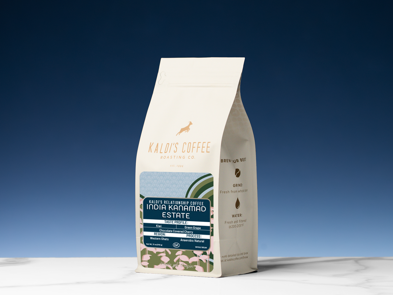 A stand-up coffee bag labeled 'Kaldi's Coffee' and 'India Kanjamad Estate' on a white surface against a blue gradient background.