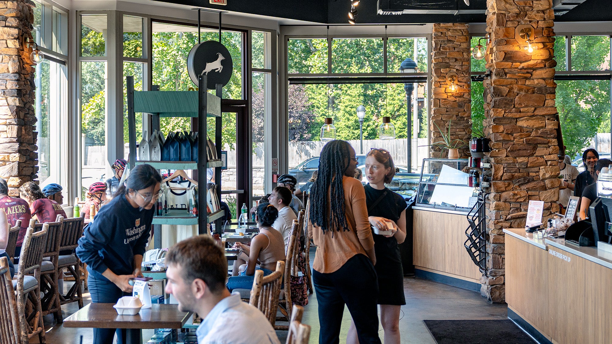 Dining area with patrons and staff inside a restaurant.